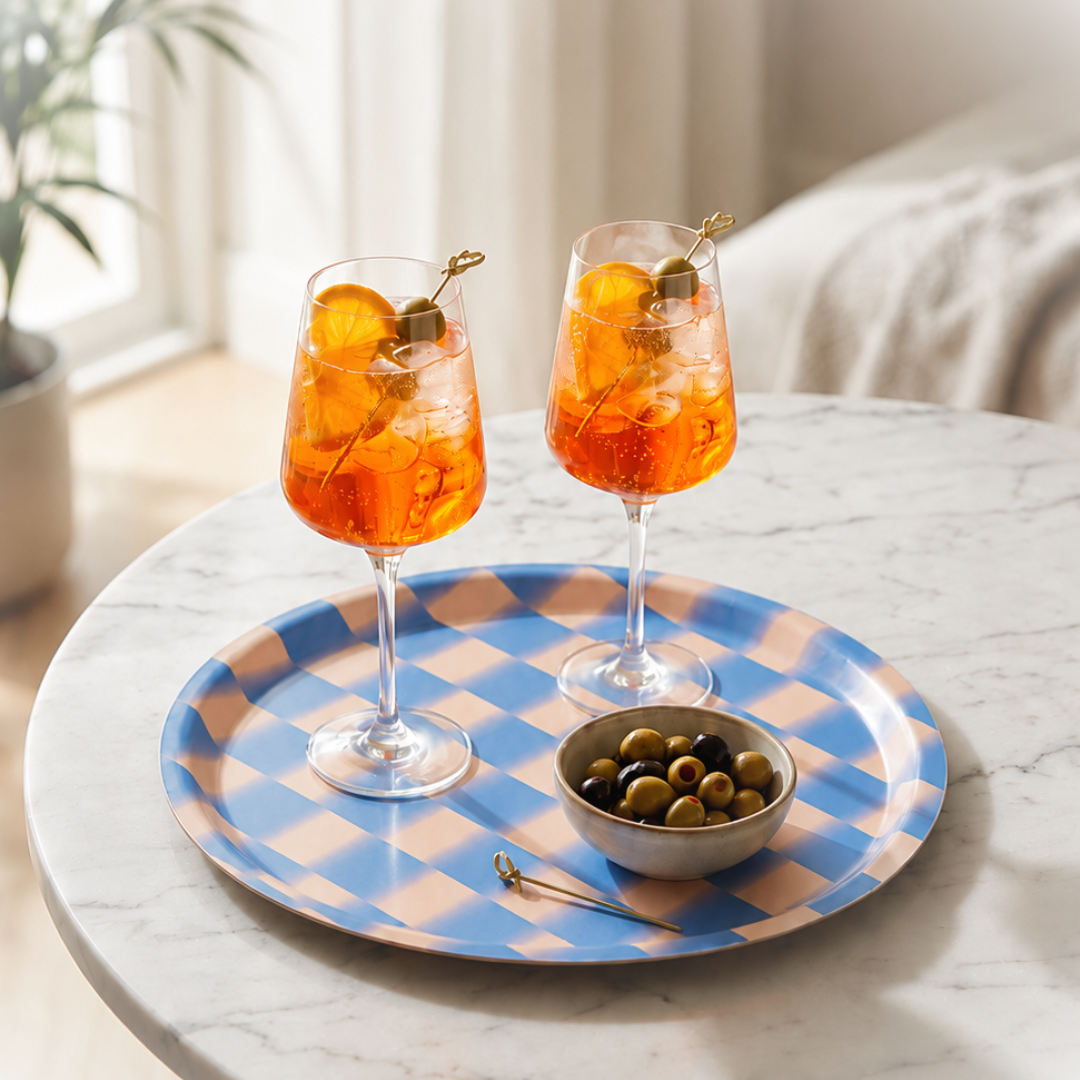Plateau rond bleu et blanc Wrap Magazine mis en scène dans un intérieur pour un apéro