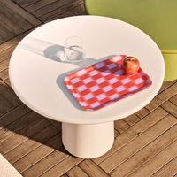 Petit plateau rouge et rose à motif damier Wrap Magazine, avec une pomme, posé sur une table extérieure blanche.

Select 74 more words to run Humanizer.